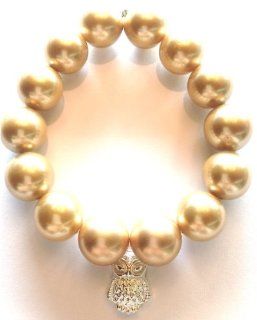 Jubel & Stern, noble golden shell bead stretch bracelet (about 14 mm) with silver owl pendant. Length about 19 ??cm. Made in Germany: Jewelry